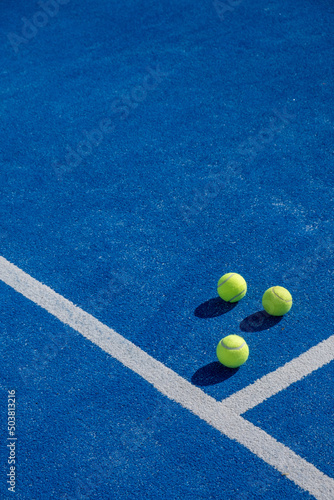 three balls on a paddle tennis court, selective focus,  © Vic