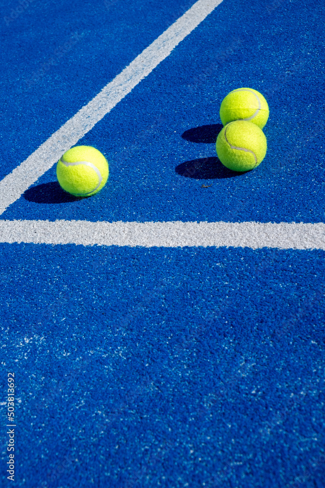 Selective focus. Three balls an the net of a paddle tennis court