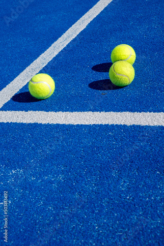 Selective focus. Three balls an the net of a paddle tennis court © Vic