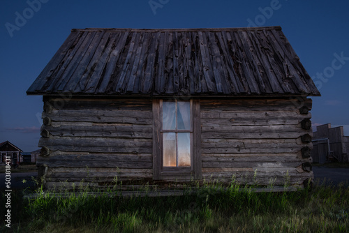 Old log cabins dot the countryside of South Dakota, illuminated