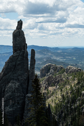 A pair of rock climbers atop a massive spire in Custer State Par