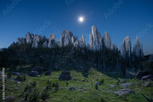 The moon sets as the massive spires of the Black Hills catch the