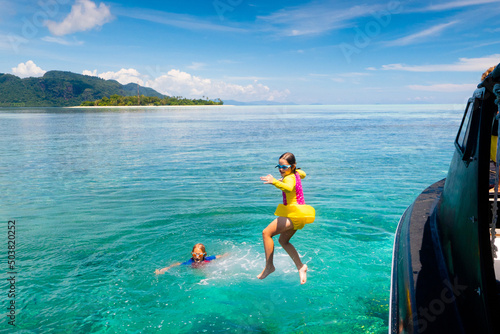 Child jumping into sea water. Yacht vacation. © famveldman