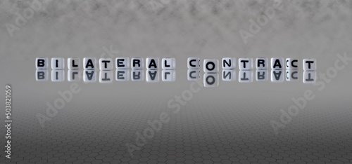bilateral contract word or concept represented by black and white letter cubes on a grey horizon background stretching to infinity