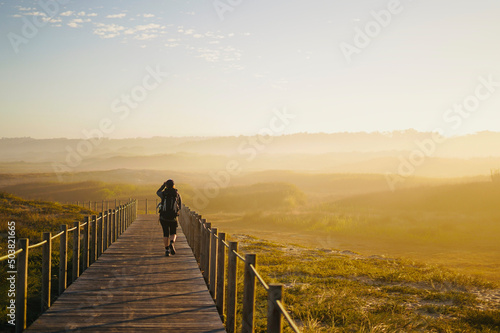 Fotografi Woman walking on the path