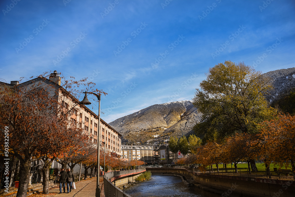 andorra landscape, a sunny day, autumn trees with river in the middle, travel concept