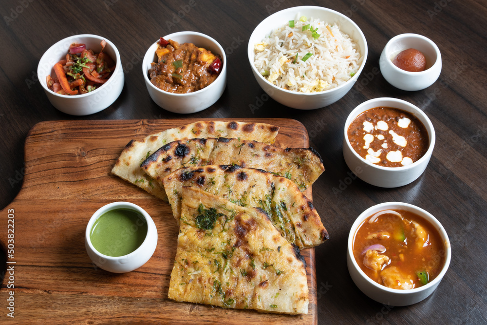 Shot of the roti sliced and types of side dishes kept on the table for ...