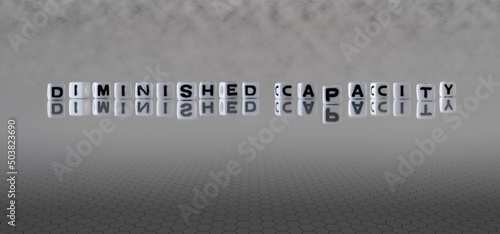 diminished capacity word or concept represented by black and white letter cubes on a grey horizon background stretching to infinity
