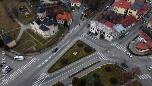 Birds-eye view shot of the Curtea de Arges city streets and buildings with colorful roofs photo
