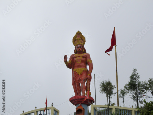 View of Haunman hindu god's statue in Kalimpong Sikkim temple with a flag and trees on background photo