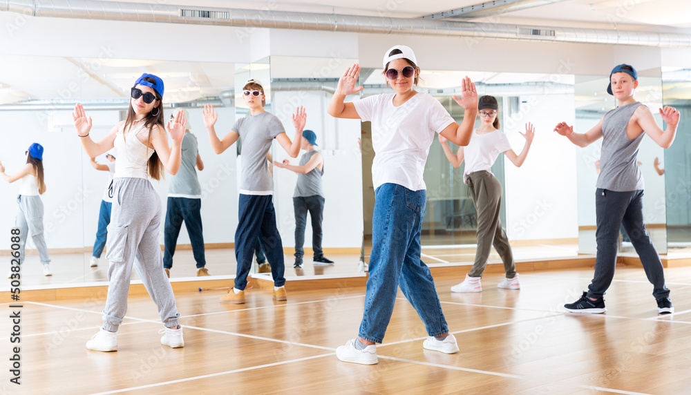 Boy and girls having dancing class in dance studio