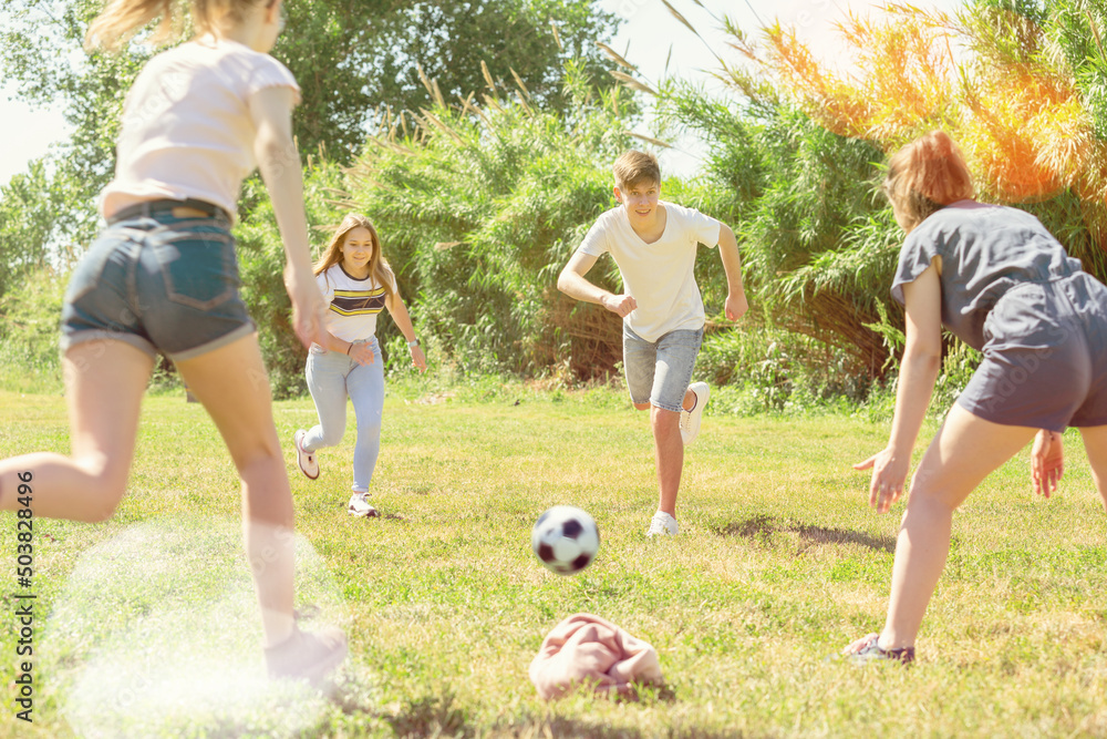 Obraz premium Teenagers play street football with excitement in city park