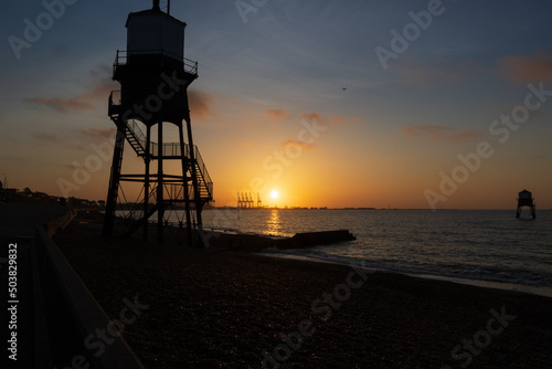 lighthouse seaside sunrise photo
