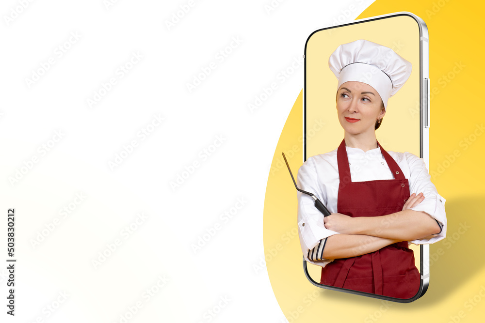 Culinary blog. Cooking training. A female chef on a smartphone screen. A smiling woman in a chef hat and apron. Place for text. Cooking Recipes online. Cooking school