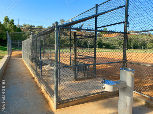 dugout baseball field chain link fence practice playground empty ballpark sports park drinking water fountain