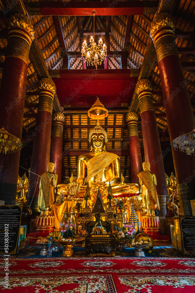 Old golden Buddha statue in a temple in Phitsanulok Province, Thailand.