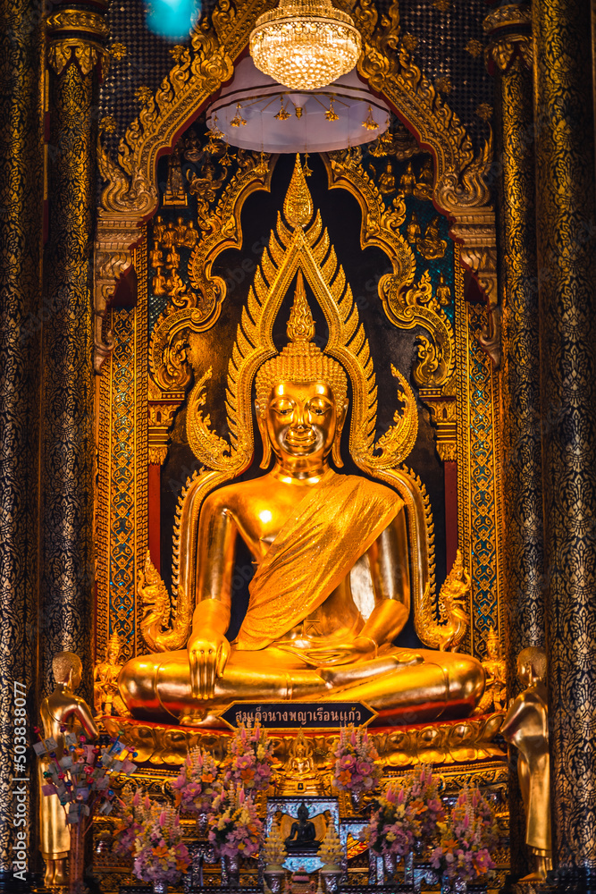 Old golden Buddha statue in a temple in Phitsanulok Province, Thailand.