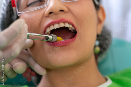 Dentist's hands injecting anesthesia into the mouth of a patient