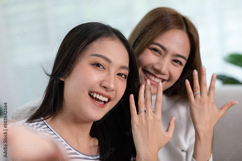 camera view young Asian women couple is taking a picture together.LGBTQ couple lesbian wearing a couples t-shirt and giggles together. They spend time together as a normal couples and LGBT conceptual camera view young Asian women couple is taking a picture together.LGBTQ couple lesbian wearing a couples t-shirt and giggles together. They spend time together as a normal couples and LGBT conceptual
