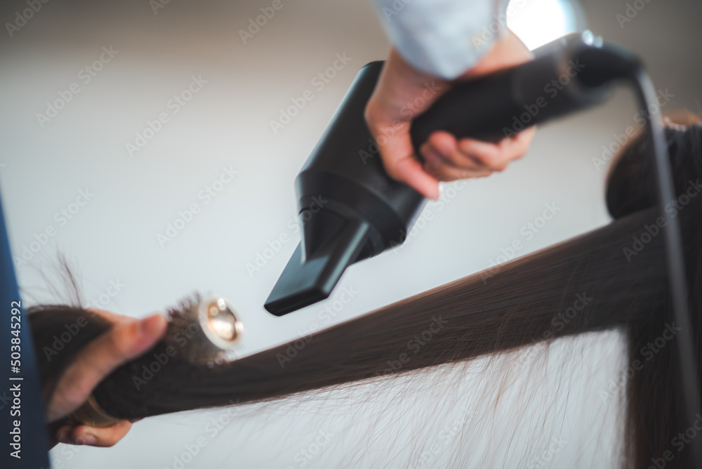 concept of professional fashion hairdresser and hair beauty salon, hairstylist making treatment to woman client person, by using scissors for haircut and coiffure care, girl style in studio lifestyle