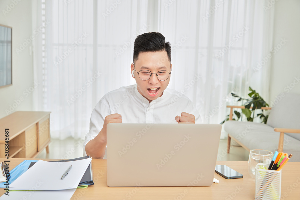 A moment of young working with laptop at home in living room background 