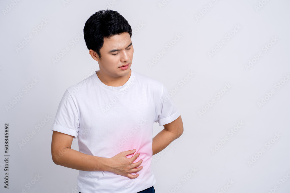 Handsome of asian man sick has stomachache isolated on white background in studio. With copy space. Handsome of asian man sick has stomachache isolated on white background in studio. With copy space.