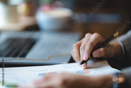 professional businessman making a business sign by a pen on deal contract document agreement paper, closeup on hand and paperwork signature form on corporate office table desk