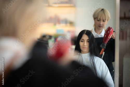 concept of professional fashion hairdresser and hair beauty salon, hairstylist making treatment to woman client person, by using scissors for haircut and coiffure care, girl style in studio lifestyle