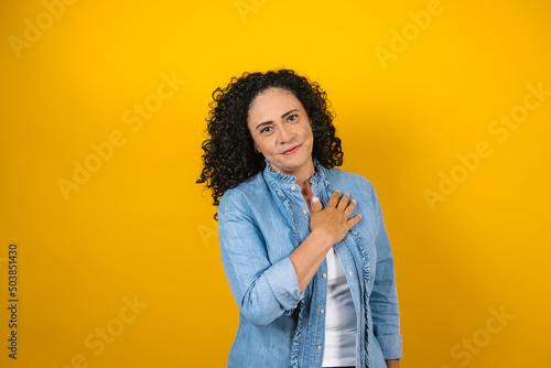 hispanic adult woman portrait on yellow background in Mexico Latin America