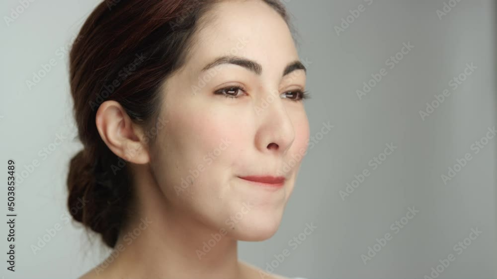Gorgeous hispanic model confidently smiles, purses lips to smooth out lipstick Gorgeous hispanic model confidently smiles, purses lips to smooth out lipstick