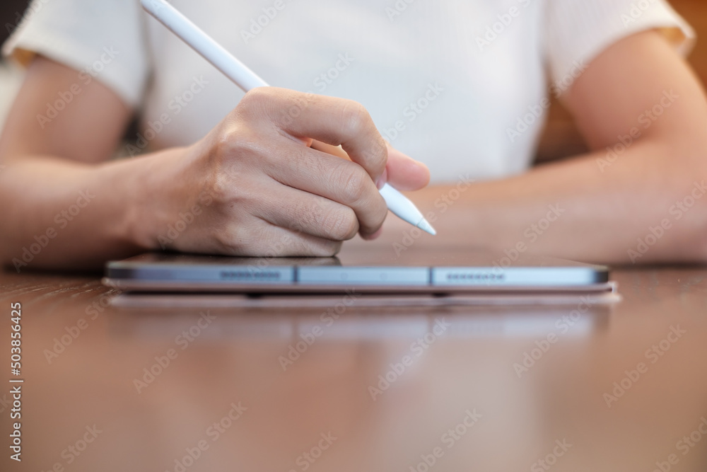 woman using tablet for sms messages, hand holding pencil typing touchscreen mobile phone in cafe or modern office. lifestyle, technology, Social media and network concept woman using tablet for sms messages, hand holding pencil typing touchscreen mobile phone in cafe or modern office. lifestyle, technology, Social media and network concept