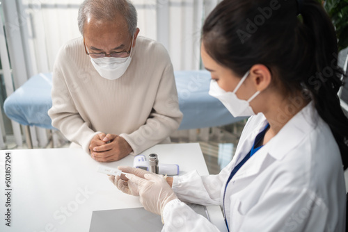 Asian senior male consult with doctor after know the result from ATK.