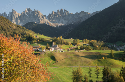 Small Italian mountain town of St. Magdalena in Val di Funes at sunset