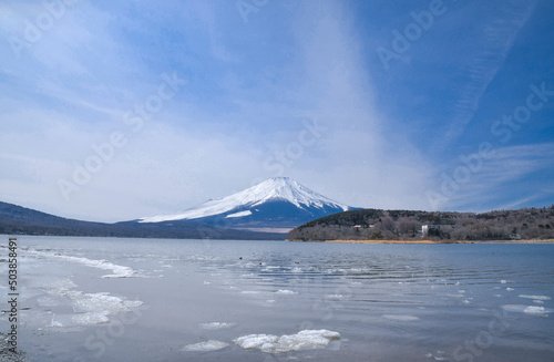 Mt. Fuji and the floating crushed ice on a lake surface after winter