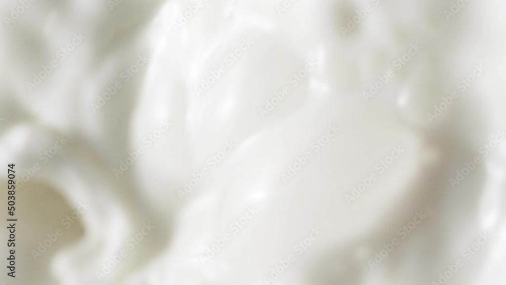 Slow motion pouring white milk, vertical splashing fresh cream drink with bubble Slow motion pouring white milk, vertical splashing fresh cream drink with bubble