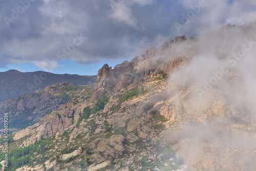 mountain peaks of Bavella in Corsica under fine clouds