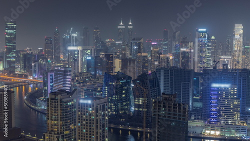 Skyline with modern architecture of Dubai business bay towers night timelapse. Aerial view © neiezhmakov