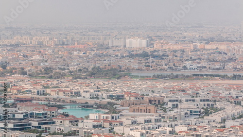 Aerial view of many apartment houses in Dubai city from above timelapse