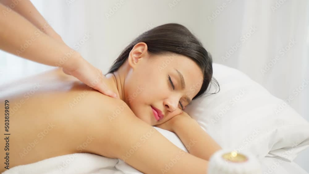 Asian young woman feeling happy and relax during back massage with oil.
Asian young woman feeling happy and relax during back massage with oil.