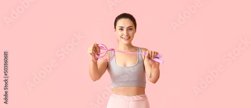Sporty young woman holding ...