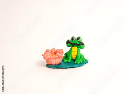 Plasticine craft green frog on a leaf of a water lily with a flower. Sculpting for children, development of motor skills. River dwellers © Наталья Занкина