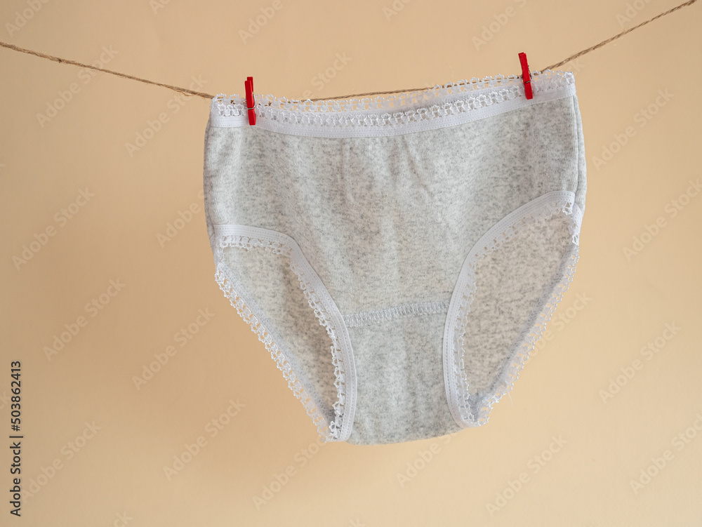 Foto de Gray panties for girls hanging on a rope attached with a