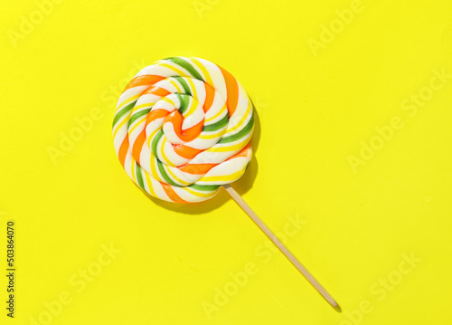 Round lollipop on color background