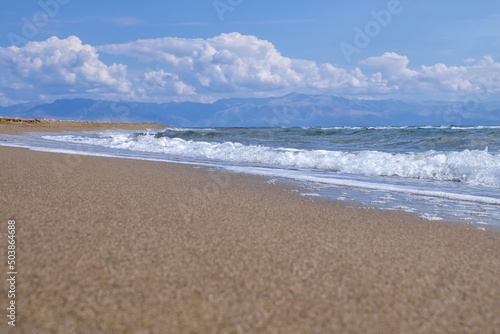 Fototapeta Naklejka Na Ścianę i Meble -  Sandy beach with sea waves at resort on sunny day
