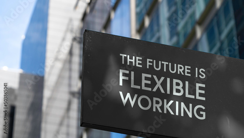 The Future is Flexible Working on a black city-center sign in front of a modern office building 