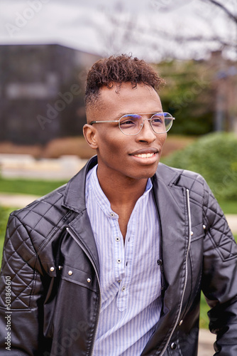 African American male model posing in a park looking at the horizon. High quality photo