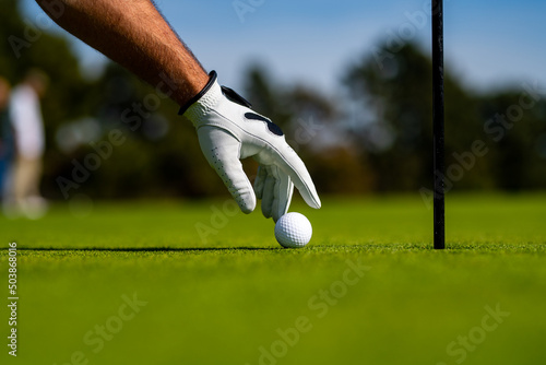 Hand hold golf ball. Golfer man with golf glove. Male hand with golf glove.