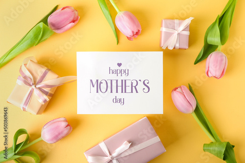 Card with text HAPPY MOTHER'S DAY, gift boxes and tulips on yellow background