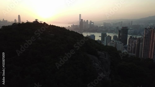 Hong Kong Victoria Harbour sunset with hiker on the mountion photo