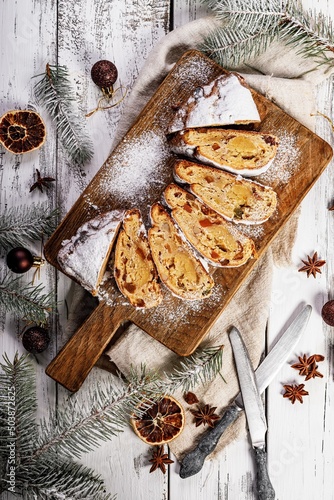 Wallpaper Mural Christmas stollen on a cutting board. Wooden white table background. Traditional Christmas pastry with marzipan, nuts, raisins and dried fruit. Top view Torontodigital.ca